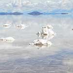 Mounds of salt poking through the water