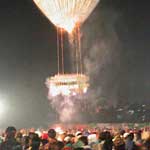 ...and the contraption underneath contains about six minutes worth of fireworks ... note that it is ascending directly above the crowd